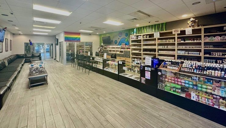 E-liquid shelves and glass display counters at the Cloud 9 Vapes 24-hour vape shop in Daphne, AL