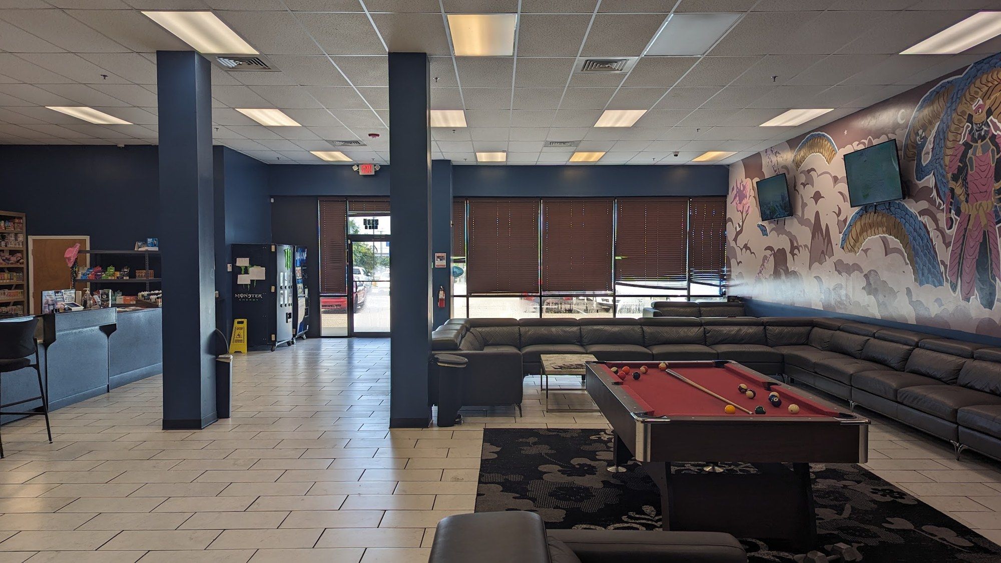 Vape lounge with a pool table, sectional couches and a mural at Cloud 9 Vapes in D'Iberville, MS