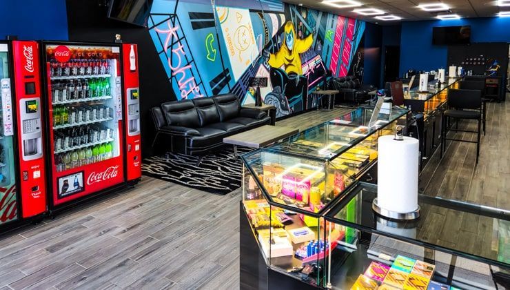 Display counter, drinks cooler and lounge seating under the mural at Cloud 9 Vapes in Saraland, AL