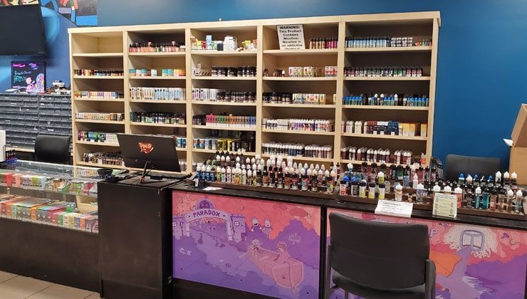 E-liquid wall at Cloud 9 Vapes Semmes Wall of e-liquid bottles on wood shelving at Cloud 9 Vapes in Semmes, AL