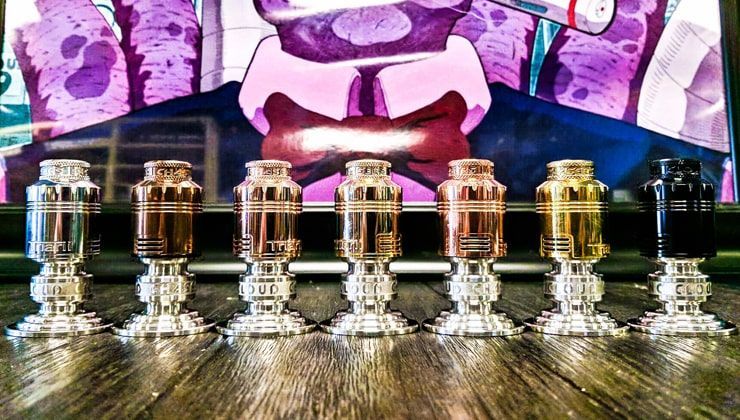 Row of vape tanks on a wood counter in front of a mural at Cloud 9 Vapes in Semmes, AL