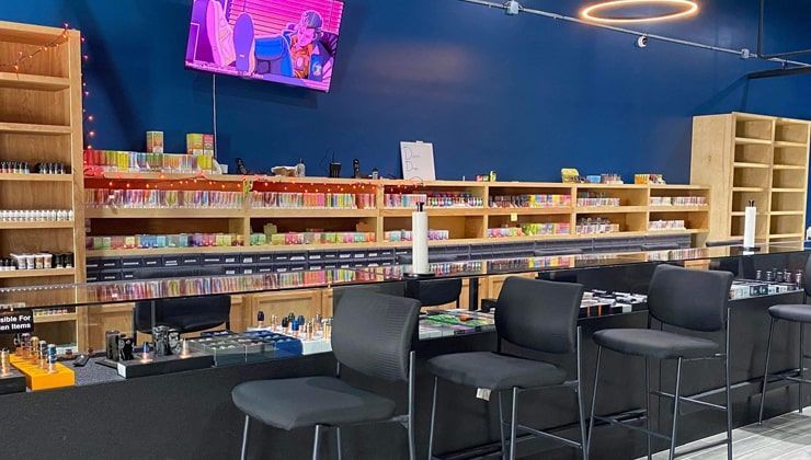 Counter seating at Cloud 9 Vapes Tillman's Corner Counter seating with a TV above the e-liquid shelves at Cloud 9 Vapes in Tillman's Corner, AL