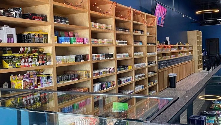 E-liquid shelves at Cloud 9 Vapes Tillman's Corner Wood shelving stocked with e-liquid and devices at Cloud 9 Vapes in Tillman's Corner, AL
