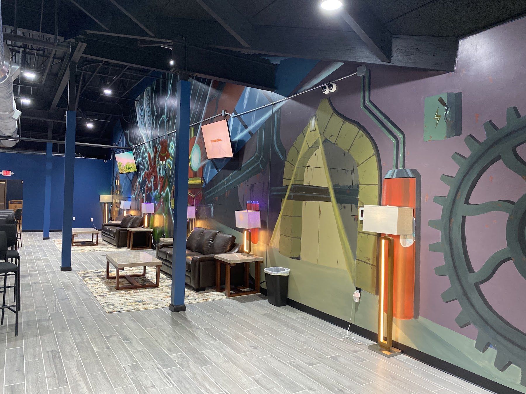 Vape lounge at Cloud 9 Vapes Tillman's Corner Vape lounge with leather couches under a wall-to-wall mural at Cloud 9 Vapes in Tillman's Corner, AL